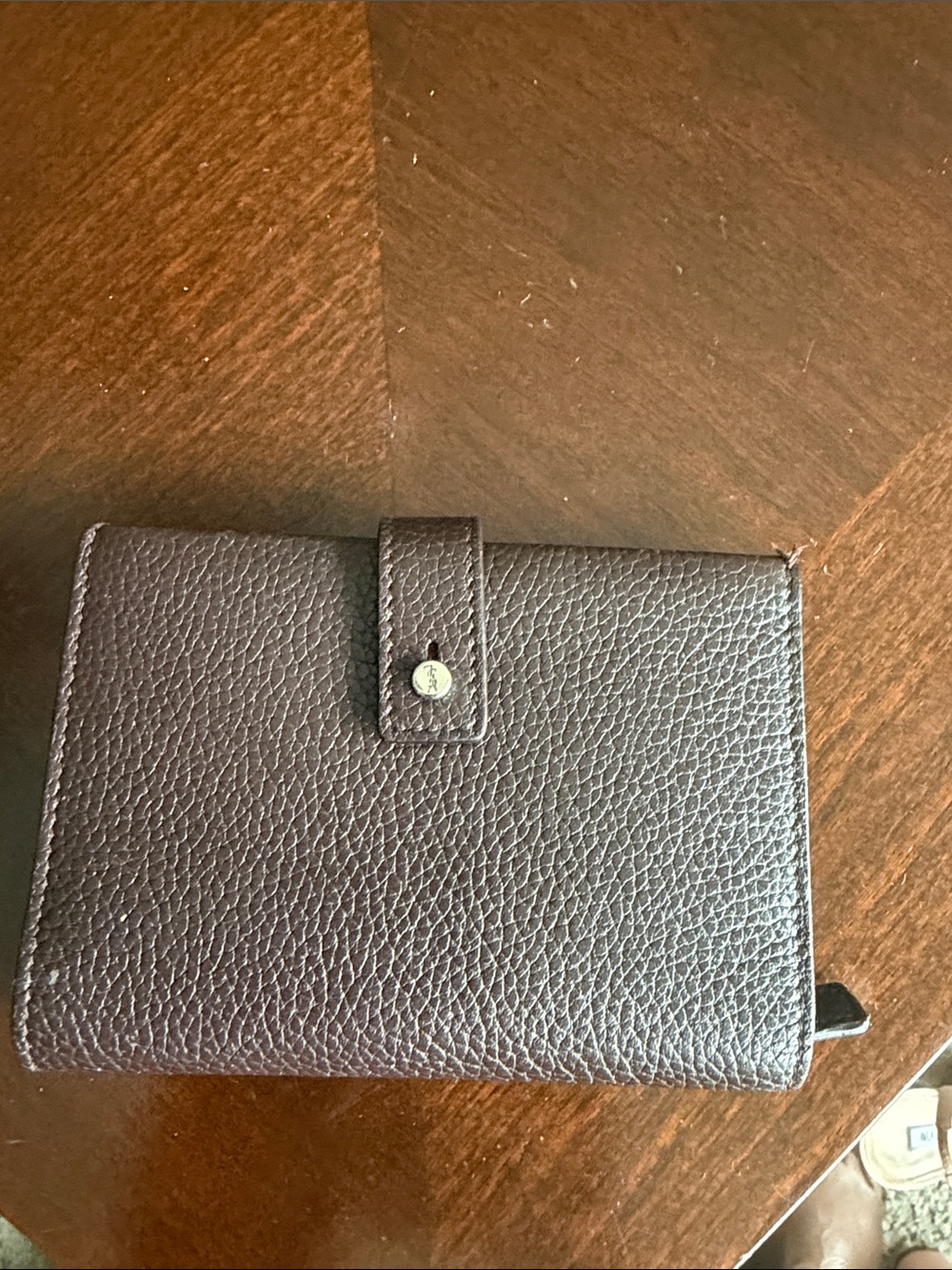 Saint Laurent’s wallet Textured Leather Snap Wallet in Dark Brown/ maroon color